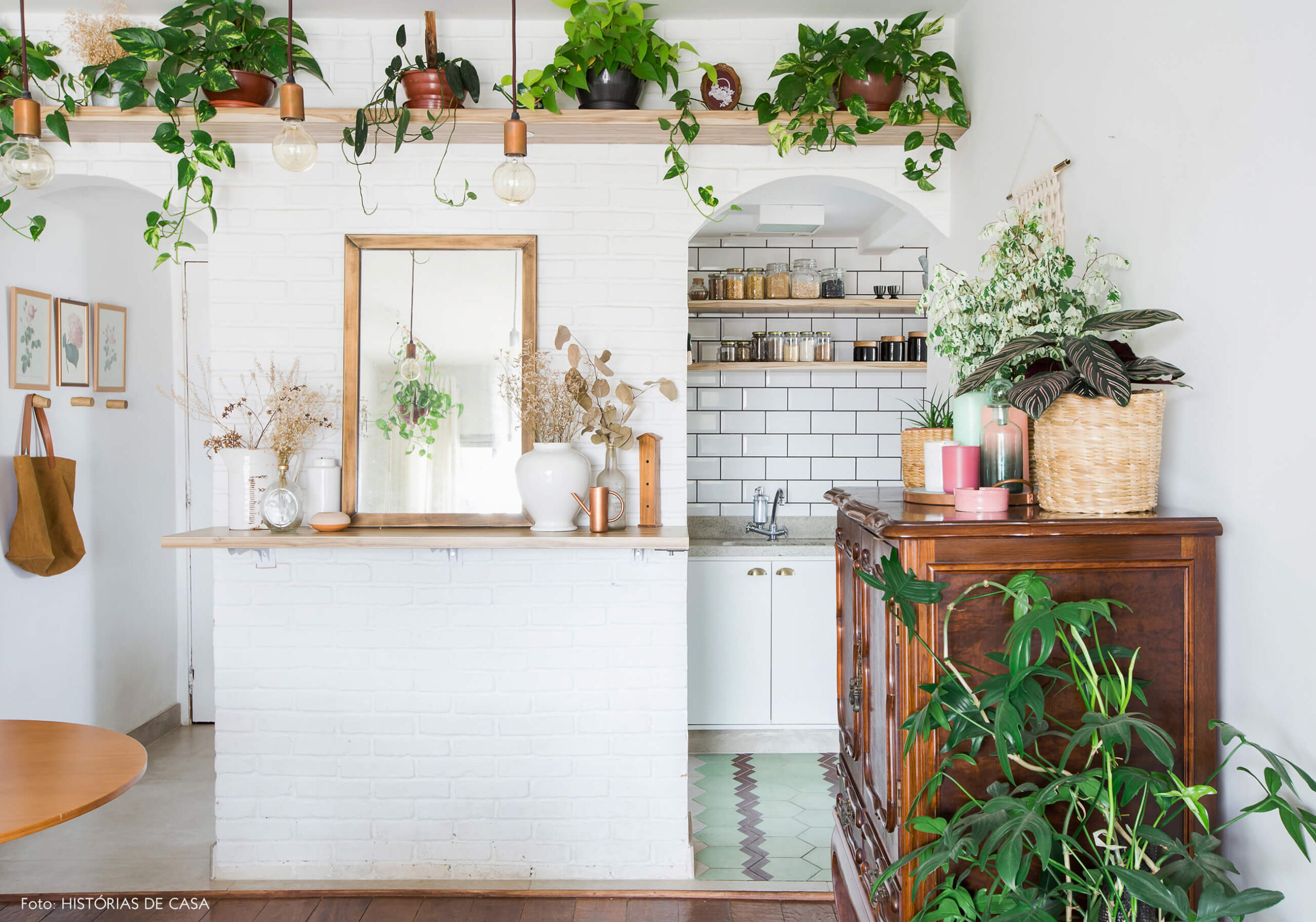Apartamento pequeno com parede de tijolinho branco e plantas
