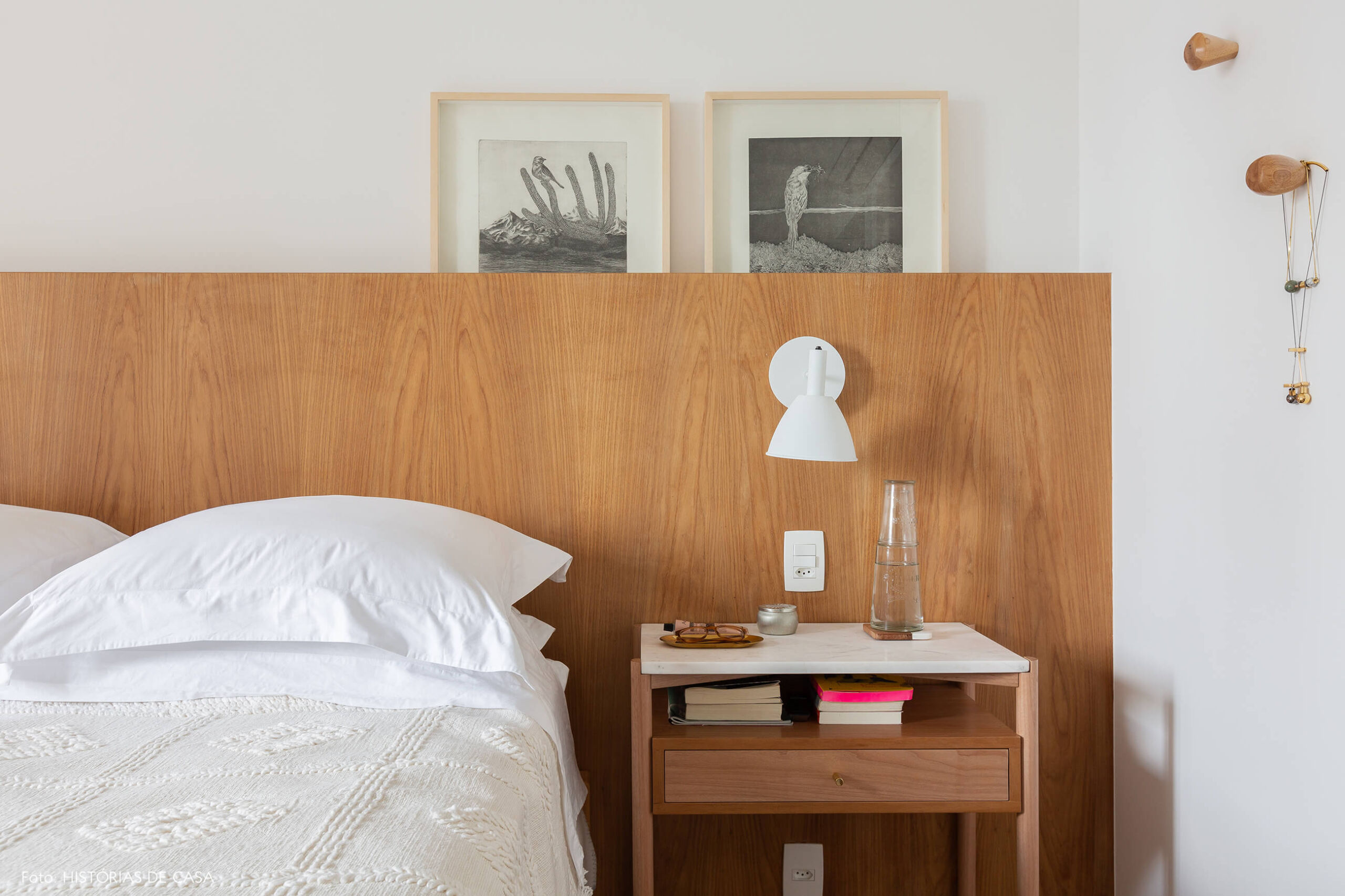 Quarto com cabeceira de madeira e tons neutros