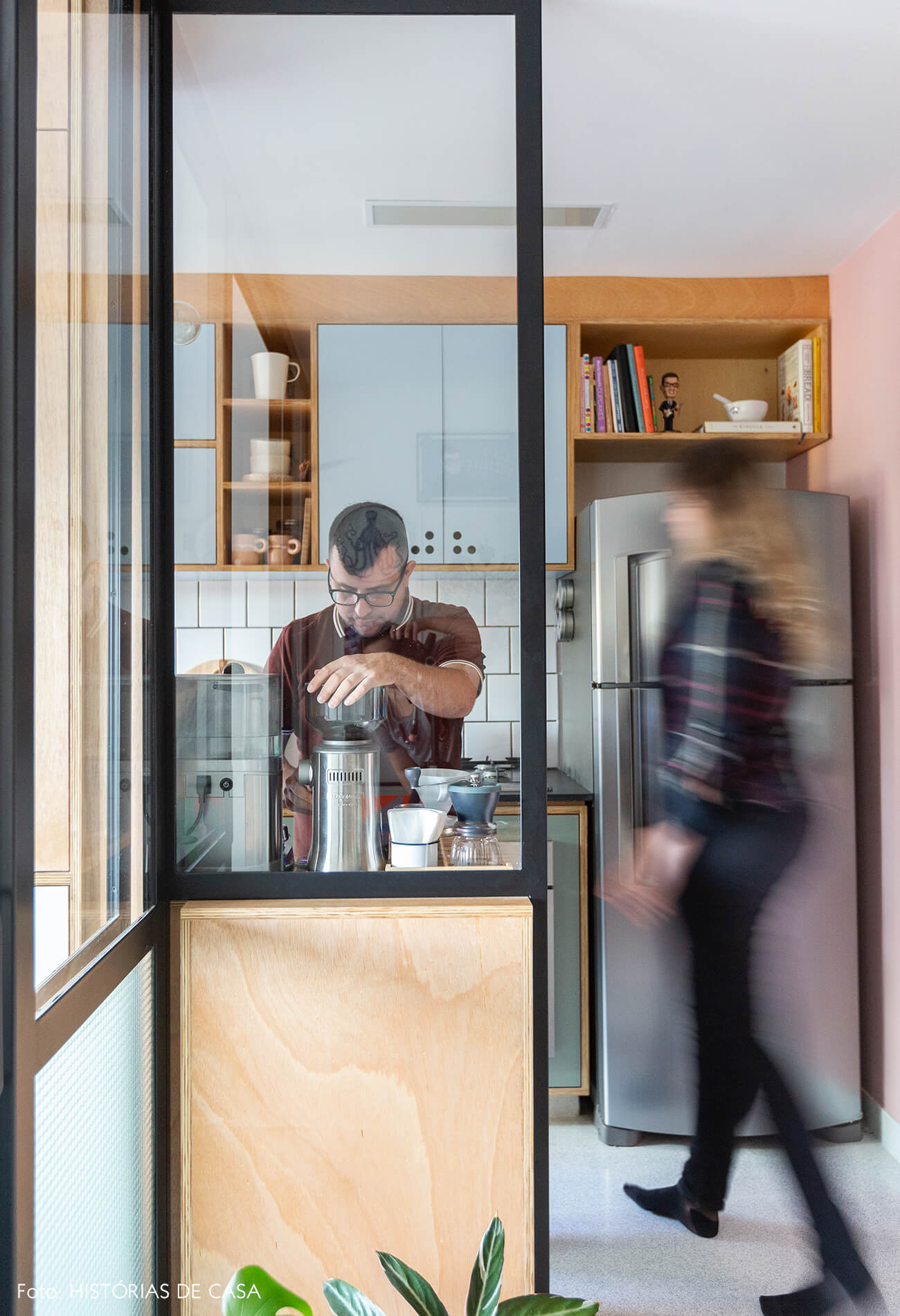 Apartamento pequeno com divisória de vidro entre a sala e a cozinha