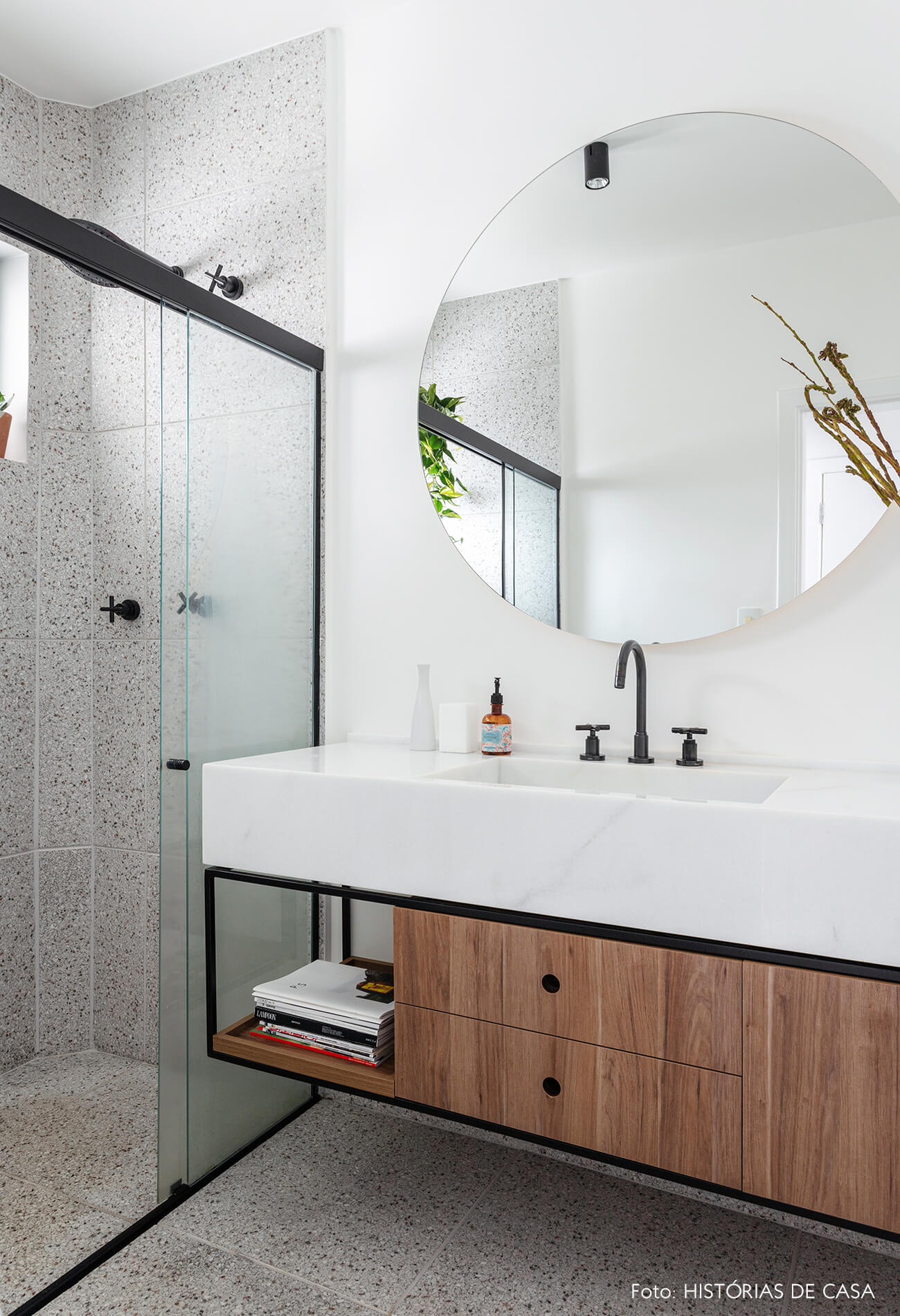 Apartamento escandinavo, banheiro com espelho redondo e tons sóbrios