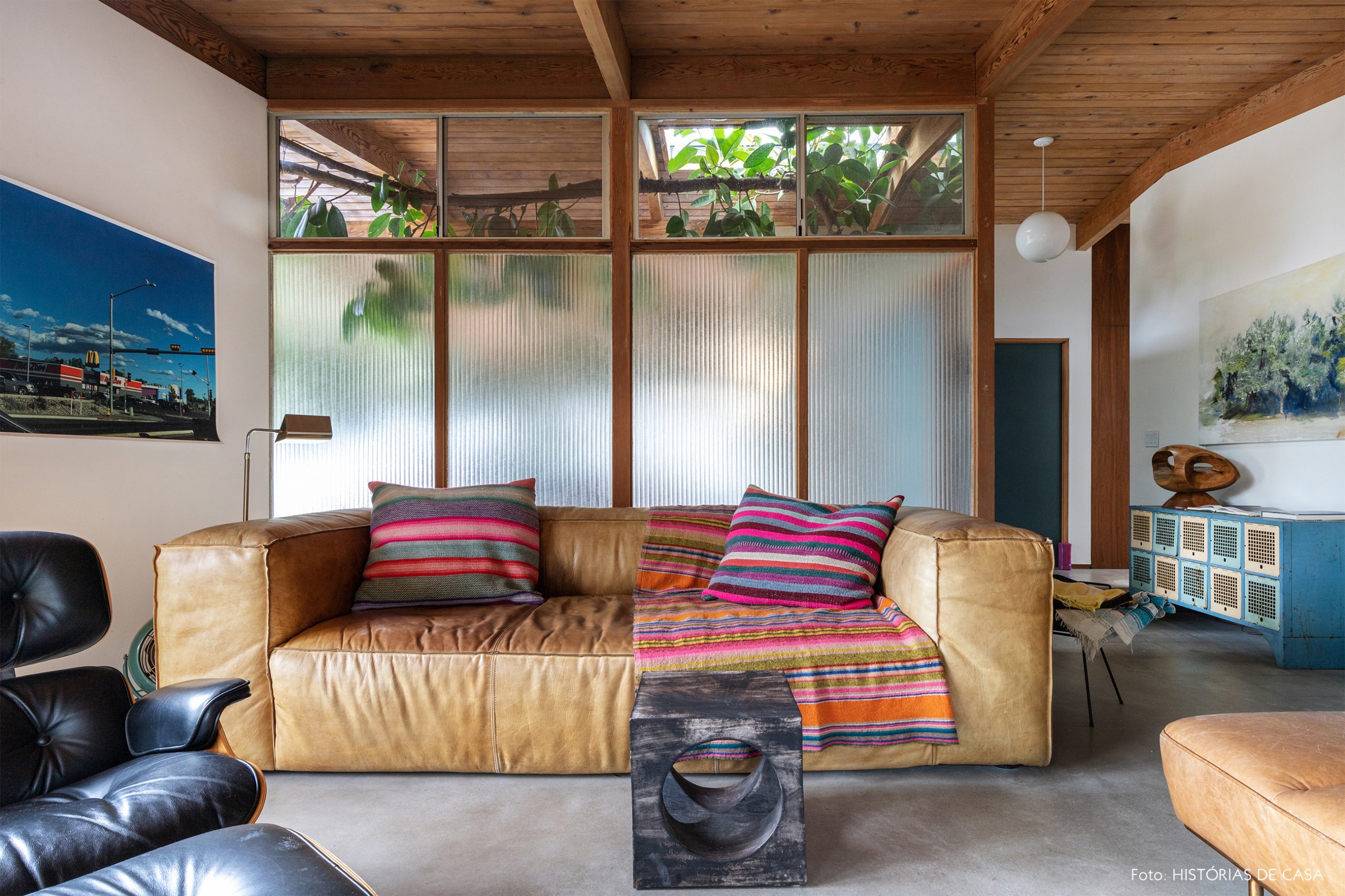 decoração casa de madeira e vidro e sala com sofá de couro e banco de madeira