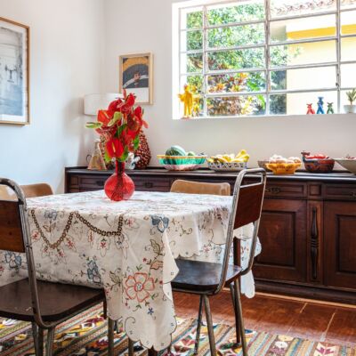 decoração sala jantar com cadeiras de ferro e madeira e tapete estampada