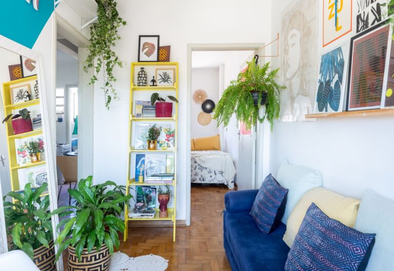 decoração sala com sofá azul, pintura geométrica e cesto