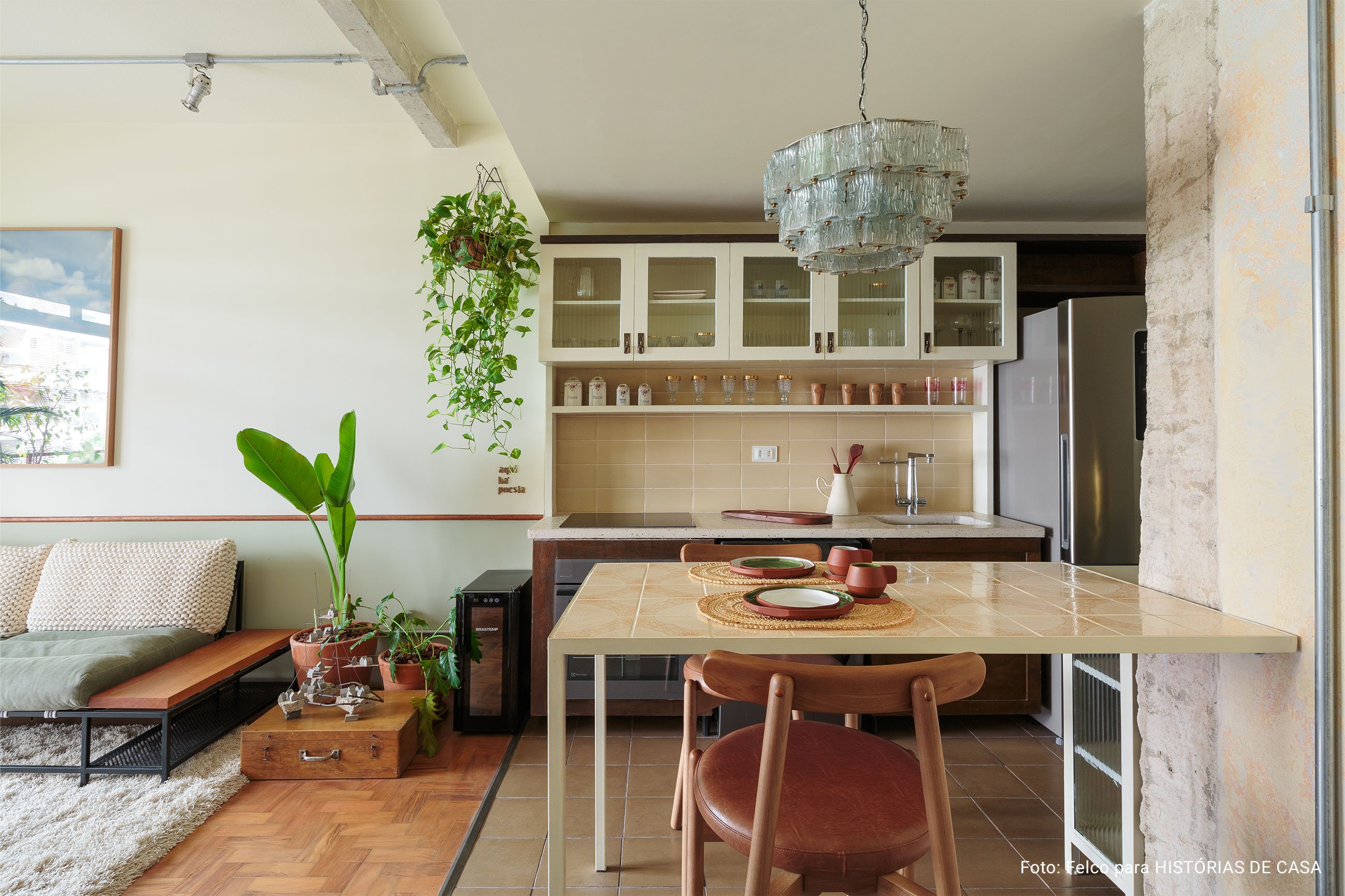 Apartamento conceito no Edifício Vírginia tem cozinha integrada, sacada com plantas, piso de taco e decoração com garimpos.