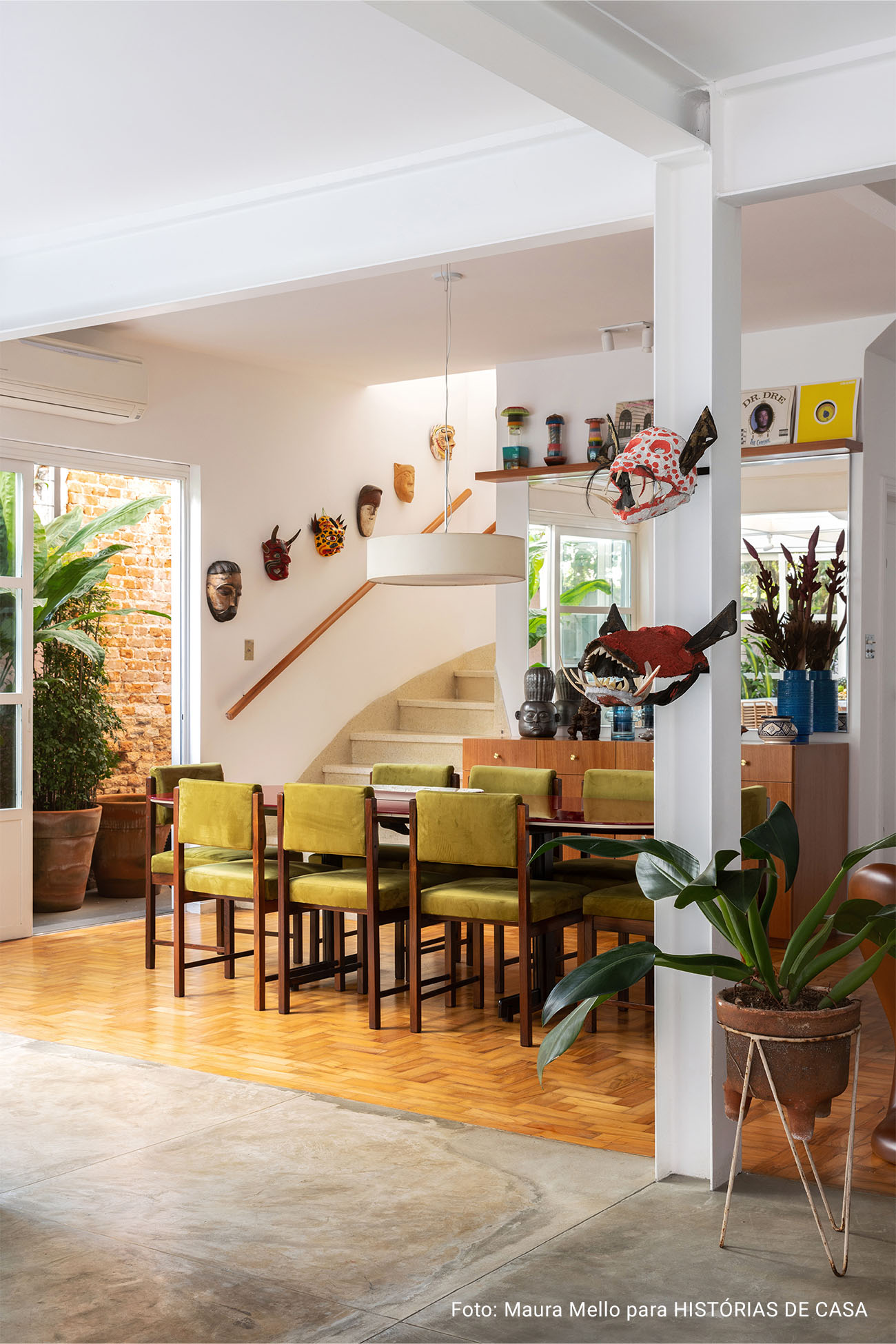 Casa com espaços integrados, muitas obras de arte e área externa cor-de-rosa.
