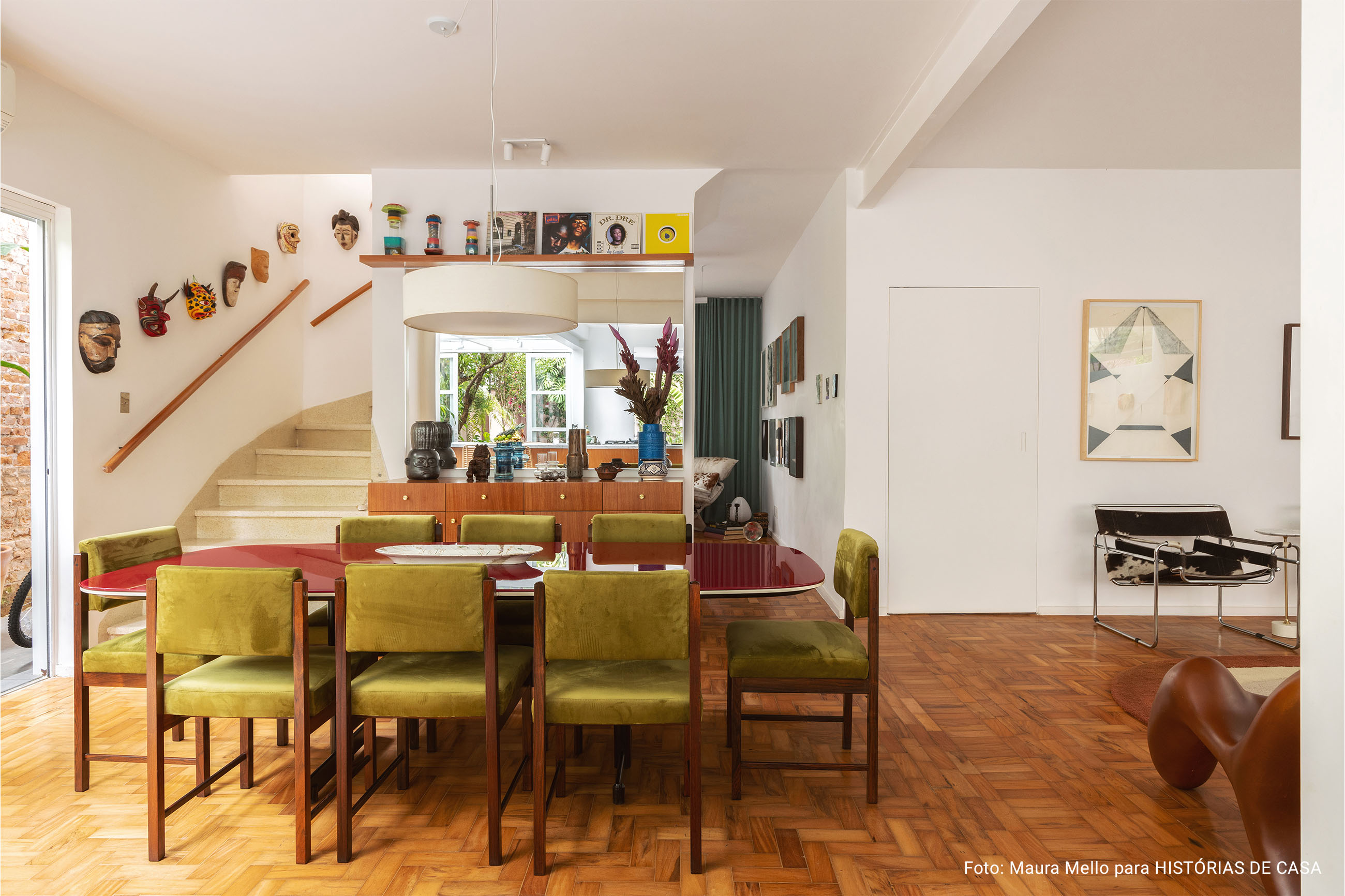 Casa com espaços integrados, muitas obras de arte e área externa cor-de-rosa.