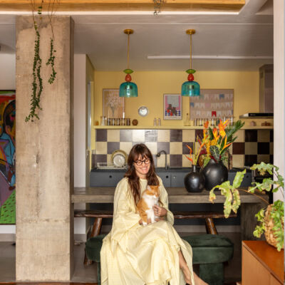 Apartamento maxmalista da Chef Cafira Foz com papel de parede, cozinha aberta com frontão xadrez e esquadrias vermelhas